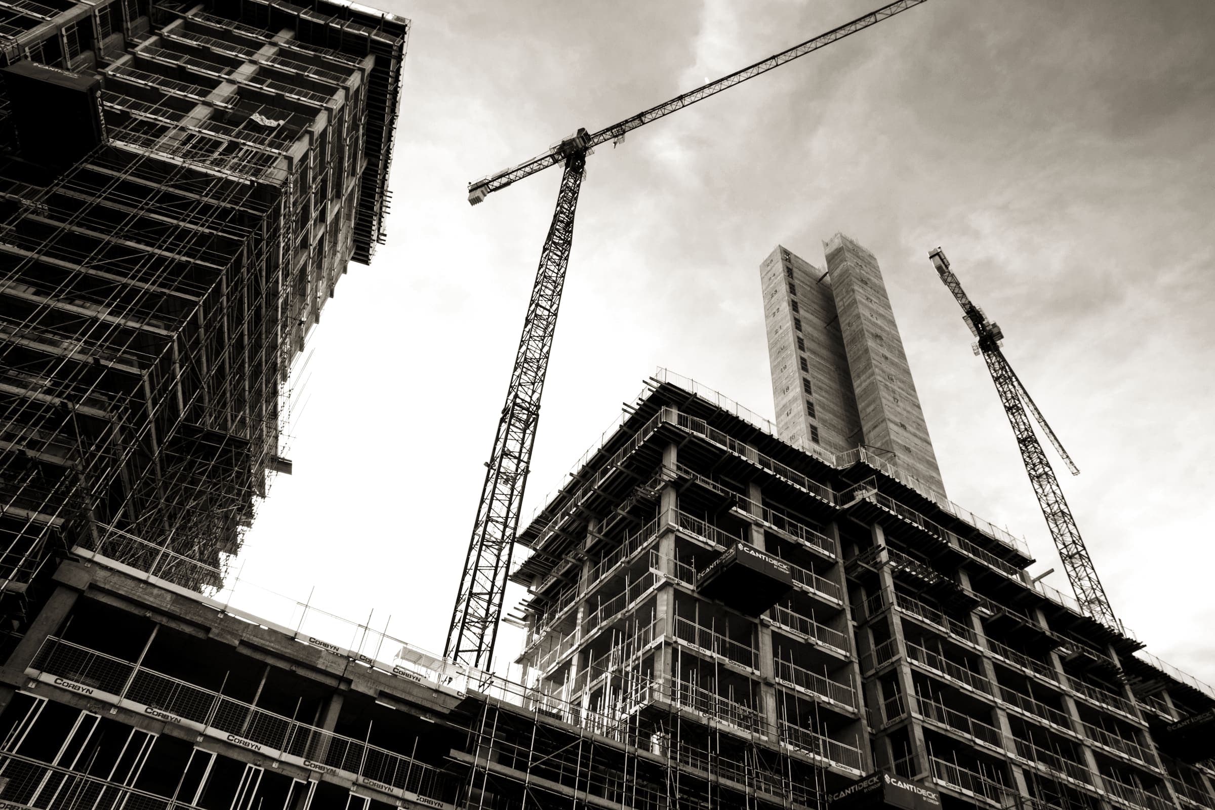 Concrete frame of a tower under construction with tower cranes